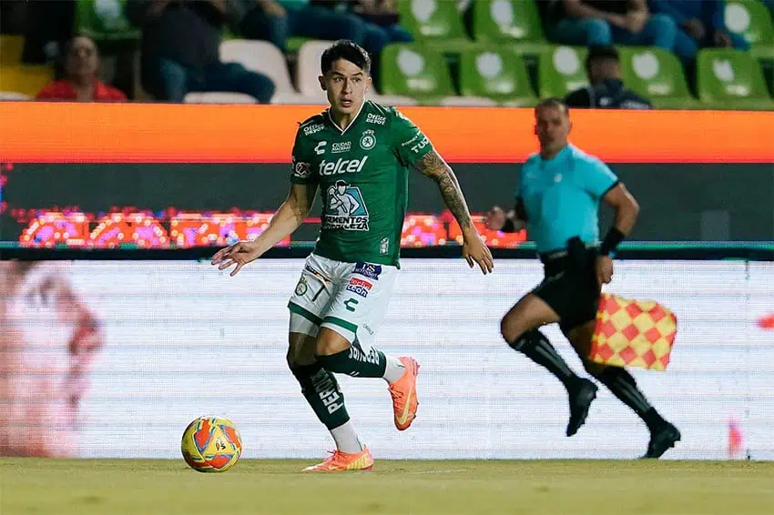 A Club León soccer or football player prepares to kick the ball