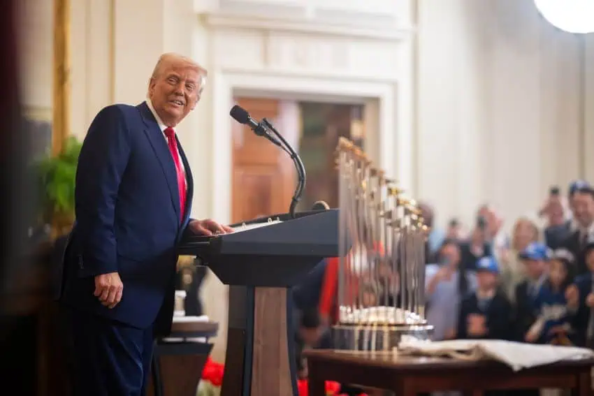 U.S. President Donald Trump smiles from behind a podium