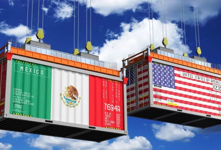 Illustration of two shipping containers hanging by cables in the air. The front of the container on stage left is painted with he flag of Mexico. The container on stage right is painted with the flag of the United States.