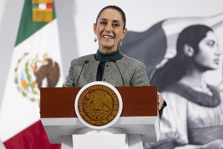 President Sheinbaum smiles from the podium of her morning press conference