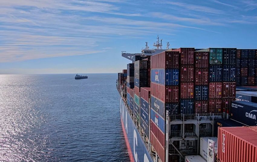 A cargo ship heads out to sea, leaving the Mexican port of Manzanillo