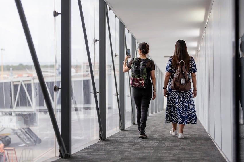 two women walking down a plane vestibule