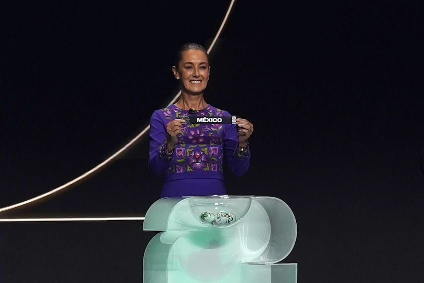 Sheinbaum holds up a small ribbon with the word Mexico at the World Cup draw on Dec. 5