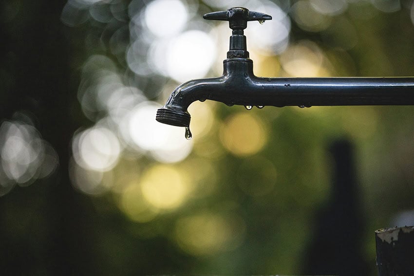Water drips from an outdoor spigot