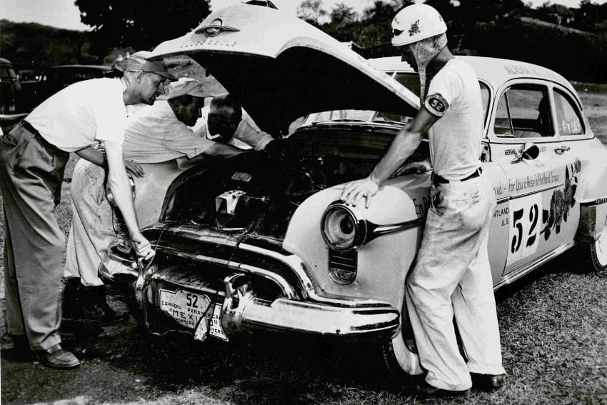 Hershel McGriff oversees repairs on his “City of Roses” Oldsmobile during the first running of the Carrera Panamericana in Mexico in 1950. (NASCAR Hall of Fame)